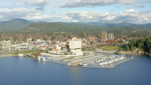 Aerial drone zooming out over Coeur d'Alene lake to see view of city