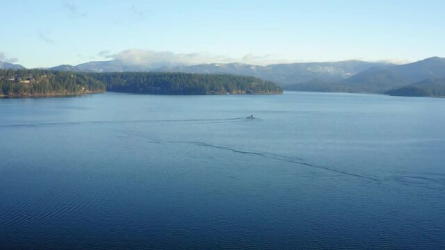 Aerial drone over Hayden Lake in North Idaho with hills and a boat