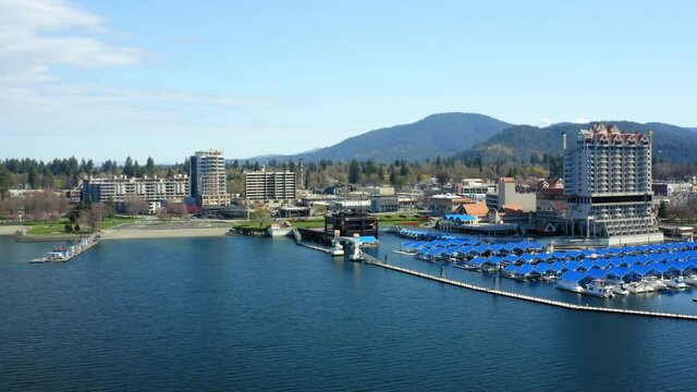 Aerial drone pan over lake with view of Coeur d'Alene Idaho skyline