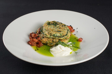 Zucchini pancakes served with sun-dried tomatoes and cream cheese