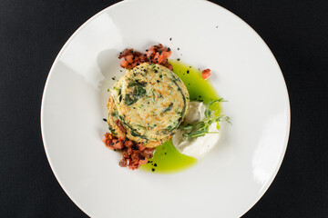 Zucchini pancakes served with sun-dried tomatoes and cream cheese