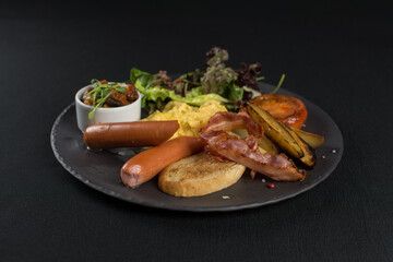 Traditional English breakfast. Sausage, beans, eggs, bread and salad