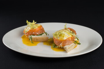 A delicious eggs benedict with lightly salted salmon and sauce.