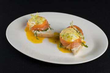 A delicious eggs benedict with lightly salted salmon and sauce.