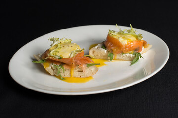 A delicious eggs benedict with lightly salted salmon and sauce.