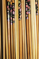 Row of Wooden Chopstick Utensils, Close Up with Flower Detail