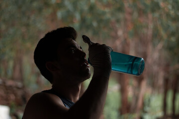 Fototapeta premium young athlete drinking water