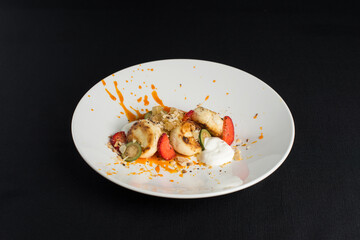 Cottage cheese pancakes with sour cream and almond flakes and sea buckthorn-orange sauce