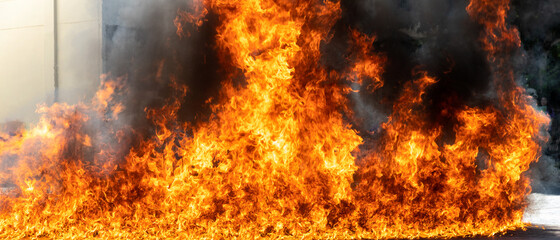 Flames caused by the explosion of the oil. Demonstration of water on oil fire. Blaze fire flame texture background.