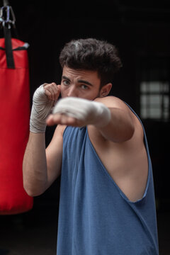 young guy shadowboxing at home