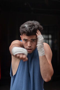boxer in handwraps throwing punches