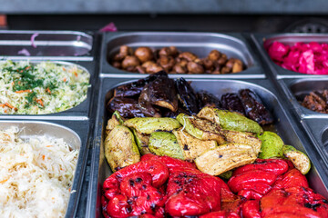 Healthy street food to go - potatoes, mushrooms, eggplants, meats, bell peppers, and red tomatoes.Delicious food cooked over an open fire, which is offered at a street food fair, event, festival.