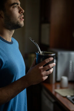 guy drinking mate in the kitchen