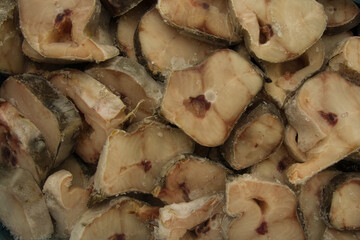 Lots of raw fish pieces. Background from frozen fish. View from above.
