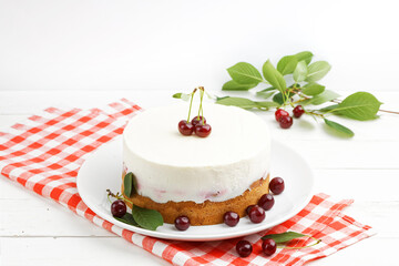 Homemade cherry pie with delicate yogurt filling on white wooden table