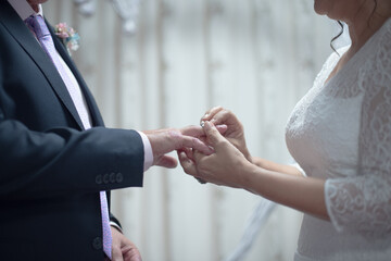 close-up of a couple wearing their ring on their silver wedding anniversary