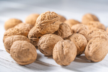 Walnuts kernels on white wooden desk, stock photo