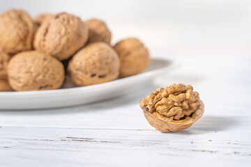 Walnuts kernels on white wooden desk, stock photo