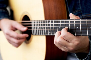 Fototapeta na wymiar Guitar playing. musician playing guitar Closeup Photography.