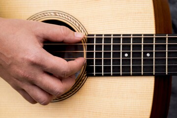 Man playing guitar at stage.