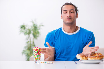 Young hungry man in dieting concept
