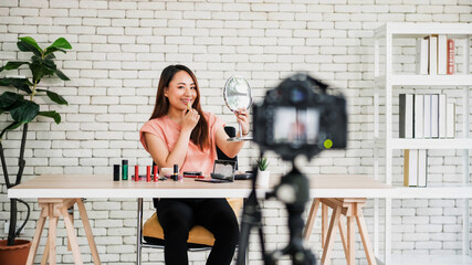 Fototapeta na wymiar Asian beauty blogger show lipstick makeup online