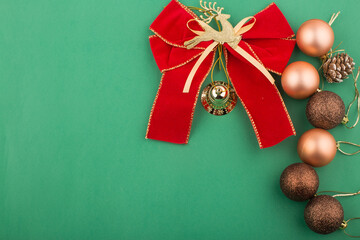 Christmas ornaments and decorations on green background.