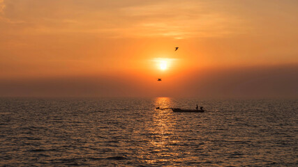 Fototapeta premium Silhouette fisherman and flying birds at sunset, Bang Pu