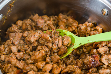 Finished fried and sliced meat is in a saucepan.