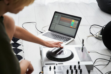 Woman making electronic music on laptop
