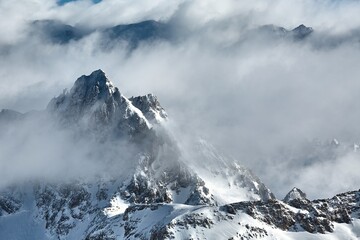 Fototapeta na wymiar Winter high mountain landscape covered in clouds and snow