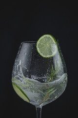 gin tonic splashing isolated on black background. Iced drink.