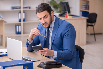 Young male businessman employee working in the office