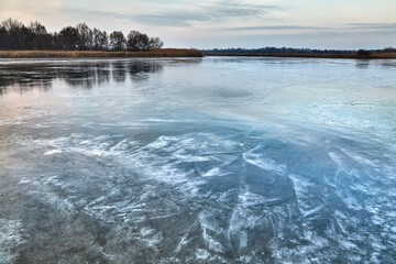 Frozen lake surface in cold winter