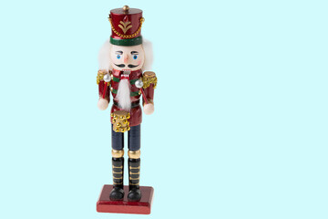 Close up view of cute Nutcracker figure on blue background. Christmas holidays concept.