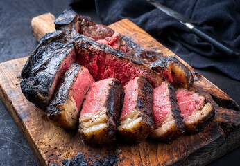 Traditional barbecue dry aged wagyu t-bone beef steak bistecca alla Fiorentina sliced and served...