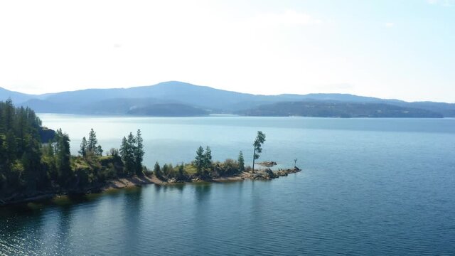 Scenic view of mountains and Tubbs Hill tree on Coeur d'Alene Lake