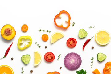 Flat lay slices of fresh vegetables and fruits isolated on white background. Top view.