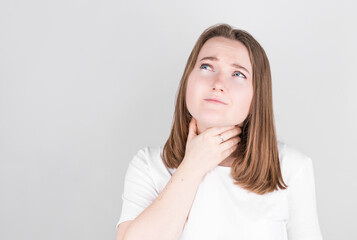 Throat pain. Ill woman with sore throat suffering from pain, touching neck with hand.