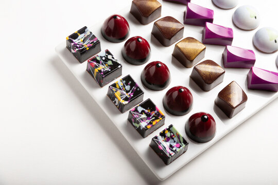 variety of luxury chocolate handmade candy bonbons with ganache on white background. Exclusive handcrafted bonbon