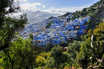 The blue city Chefchaouen / City view of the blue city Chefchaouen with dramatic sky, Morocco,...