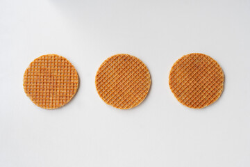 caramel holland waffles standing next to each other on white background. creative loading design.
