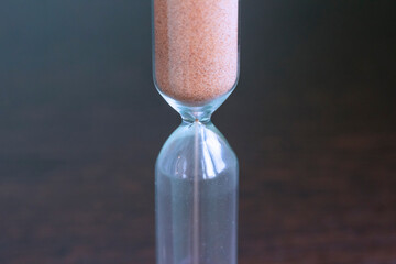 Sand pouring in an hourglass.
