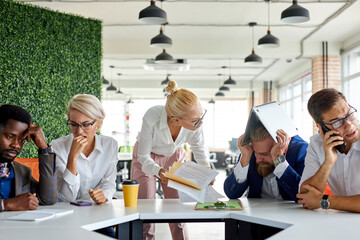 team of sad frustrated employees receiving rebuke by shouting female executive, workers are suffering from bad attitude from angry boss