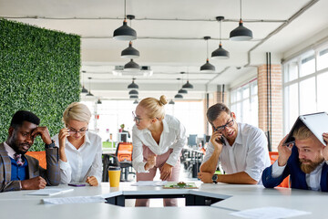 team of sad frustrated employees receiving rebuke by shouting female executive, workers are suffering from bad attitude from angry boss
