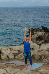 Woman Practicing Yoga on the Scenic Maui Coast