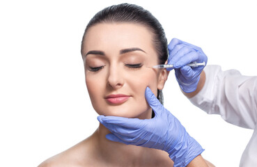 Cosmetologist makes rejuvenating anti wrinkle injections on the face of a beautiful woman. Female...