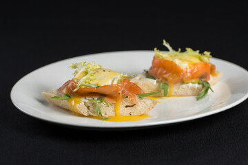 A delicious eggs benedict with lightly salted salmon and sauce.