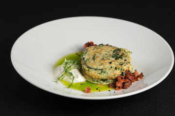 Zucchini pancakes served with sun-dried tomatoes and cream cheese