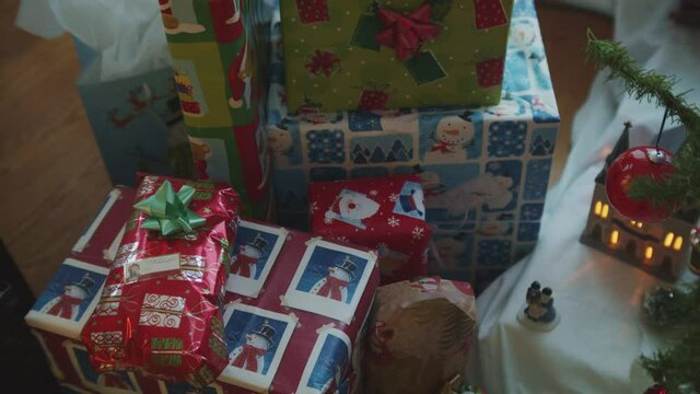 Pan across colorful Holiday Christmas presents cheerful